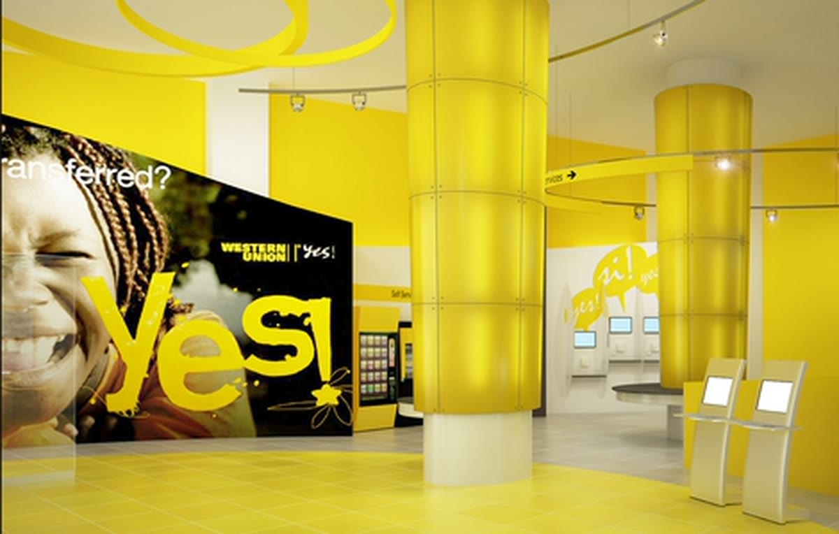 A Western Union retail interior with branded columns and self service kiosks